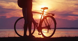 Silhouette of a bicyclist overlooking the sunset. 