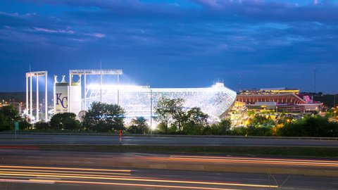 KANSAS CITY, MO - 2018: Kauffman Stadium Exterior Night Timelapse with Streaking Lights from Moving Traffic on Passing Interstate during a Baseball Game at the Popular Sports Venue