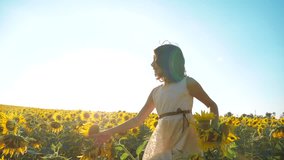 Happy little girl running happy free across the field with sunflowers. slow motion video. smelling big sunflower on summer lifestyle field. Delight of a pleasant smell. Summer holiday. concept