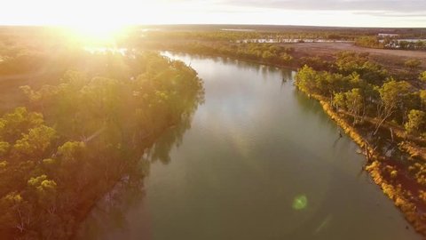 Backward flight above Murray River in South Australia at sunset