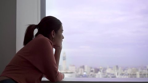 PTSD Mental health concept, Young depressed asian woman sitting alone near window in evening time.