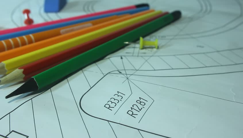 multicolored pencils fan-shaped on a piece of paper, stationery close-up
