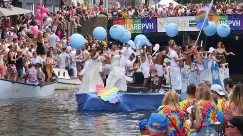 AMSTERDAM, THE NETHERLANDS – AUGUST 4, 2018: Iran refugees boat and visitors at the Canal Gay Parade 2018
