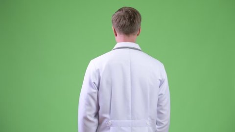 Back View Of Young Man Doctor Turning