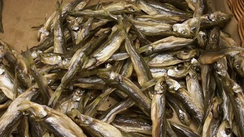 Dry fish in the market. A lot of small, sun dried stockfish. Closeup shot, pan, 4k.