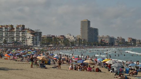 Peniscola, Spain - July 12, 2018: Time lapse of holidaymakers vacationing on the popular Platja Nord at Peniscola Beach Resort on the Mediterranean Sea, Castellon, Spain