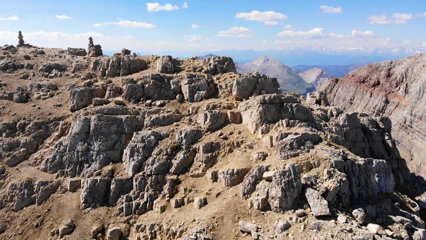 Aerial view over Tofana Di Mezzo peak in Dolomites. Climbers on top of the mountains. People silhouette on the summit. On the ridge. motivational concept. Hikers on the Italian Dolomites
