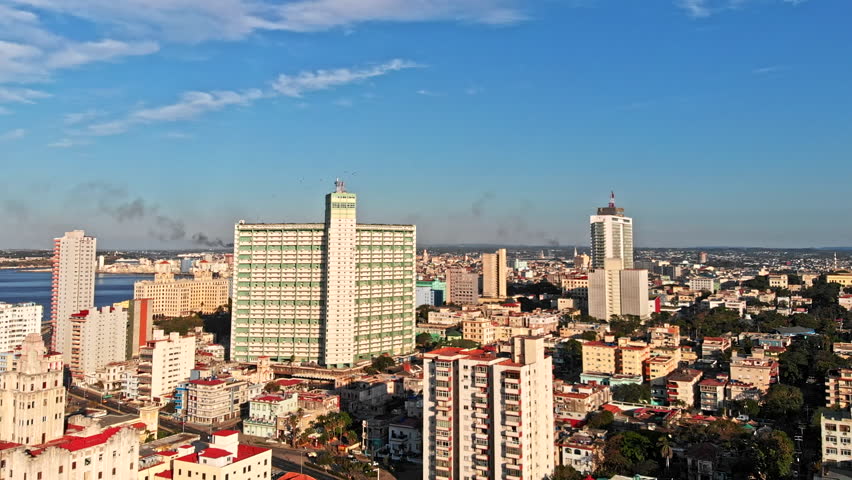 Cuba Havana v36 Flying over water front cityscape with tall apartment building detail, birds 4/18