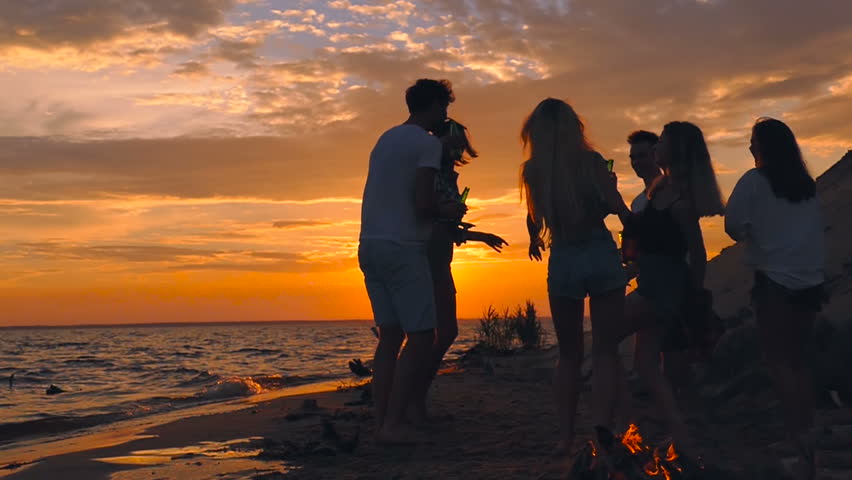 Friends having fun on the beach party during the sunset time. | Shutterstock HD Video #1014709367