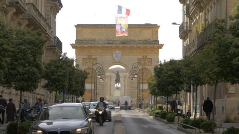 Montpellier, France - April, 2017: Equestrian statue seen behind Porte du Peyrou, in Montpellier.
