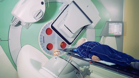 Elements of a linear accelerator are revolving around a patient