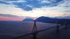 Aerial bird's eye drone video of state of the art suspension bridge crossing Rio and Antirio at sunset, Rio, Peloponnese, Greece