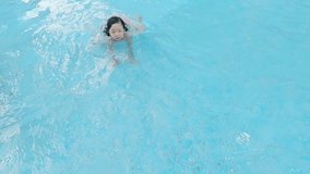 cute girl paly happily in the swimming pool