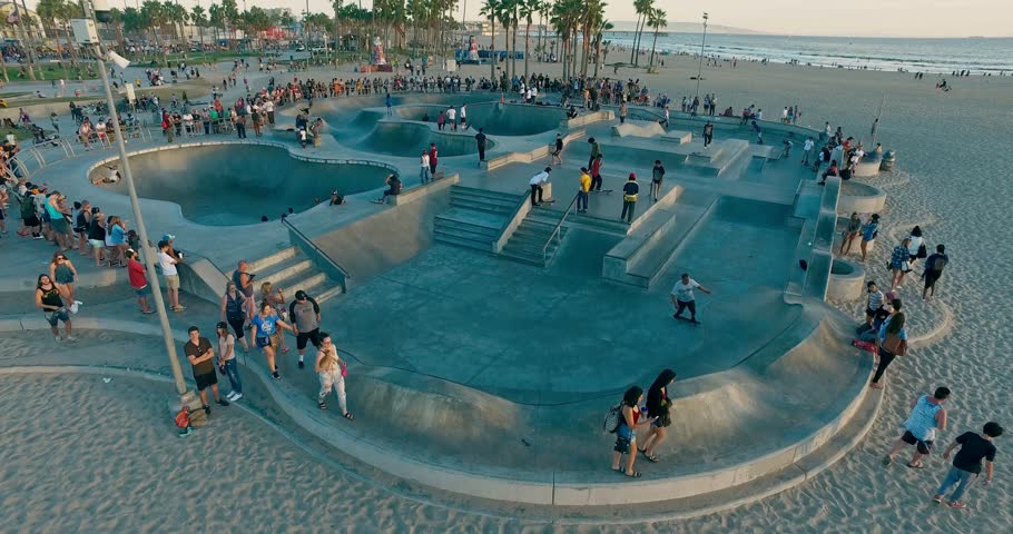 Drone flies under famous skate park in the Venice Beach, Los Angeles on sunset.