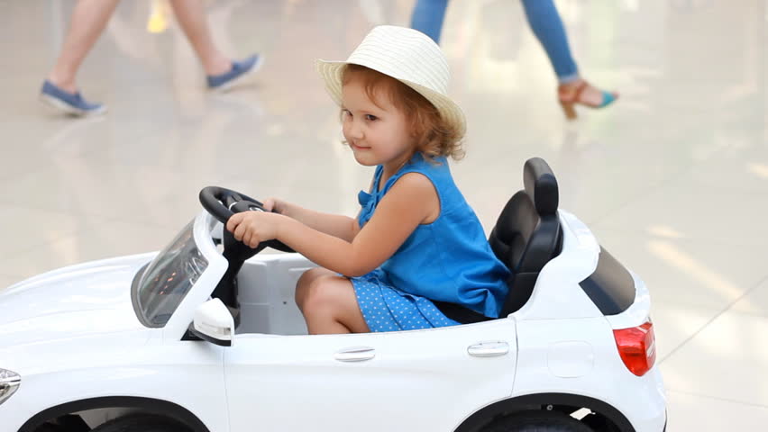Child is riding an electric car. Games and toys for children Royalty-Free Stock Footage #1014732647
