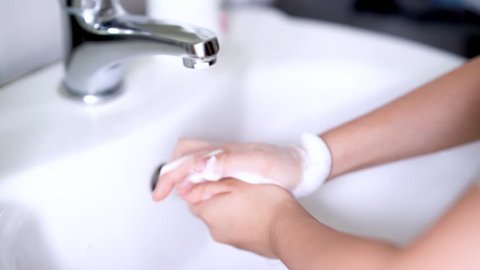 Child Washing Hands with Liquid Soap at Sink Faucet in Slow Motion
