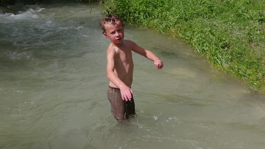 funny boy bathes in the river