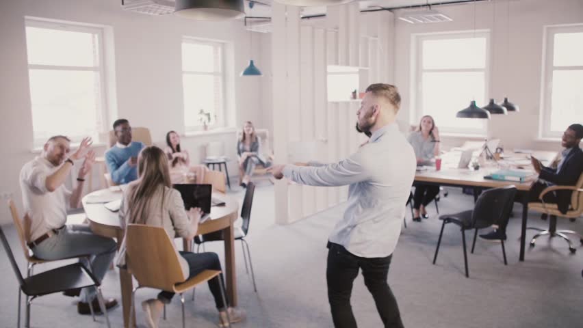 Excited man entering multiethnic office, doing funny celebration dance to share success with colleagues slow motion. | Shutterstock HD Video #1014741416