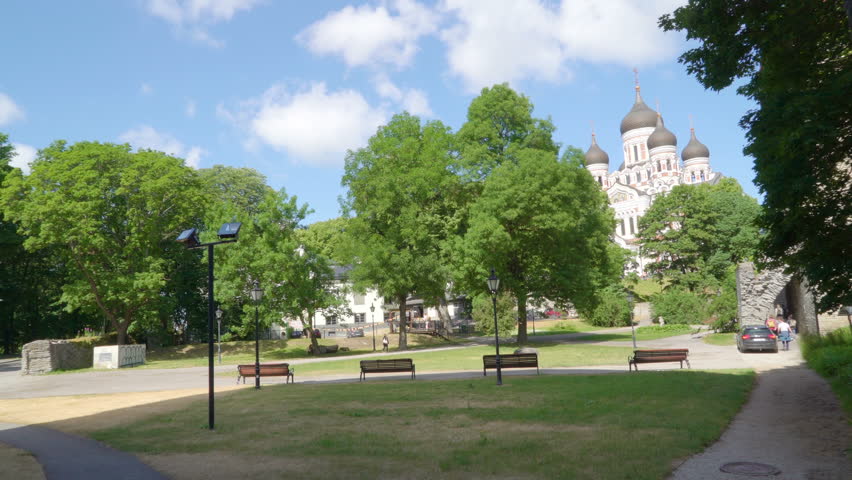 The black gate outside the Nevski cathedral in Tallinn Estonia with the benches on the side walk area