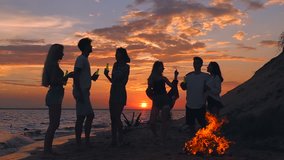 Group of friends on the beach. Sunset. Slow motion. - Powered by Shutterstock - Get 15% off with code: PIKWIZARD15