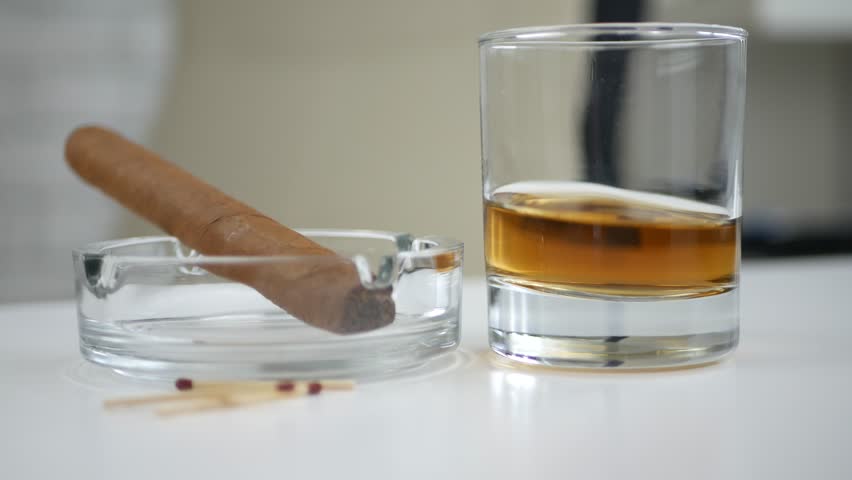Image with Cigar Ashtray a Glass with Whisky and Matches on the Table Royalty-Free Stock Footage #1014766838