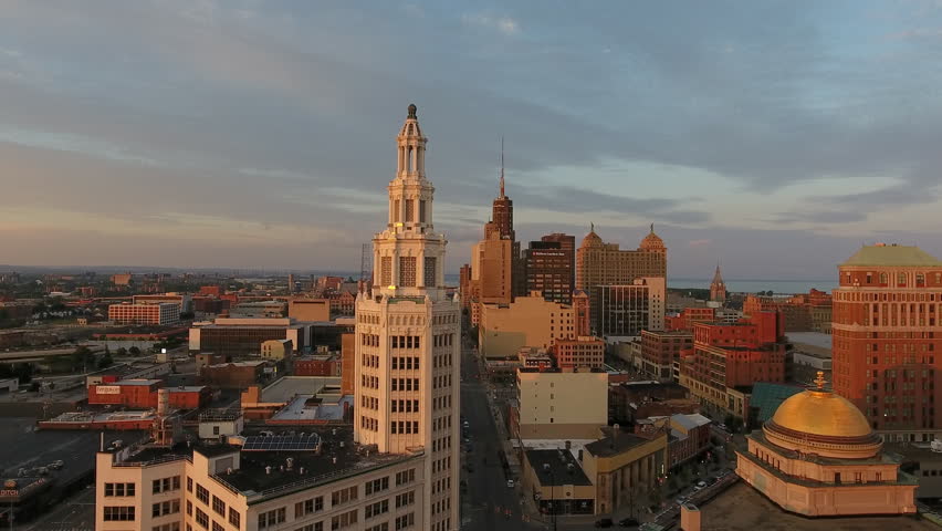 Aerial of Downtown Buffalo New York at Sunrise. Flying at sunrise in Buffalo NY. Urban city establishing shot with tall buildings. Dramatic city scene from above. Royalty-Free Stock Footage #1014769574
