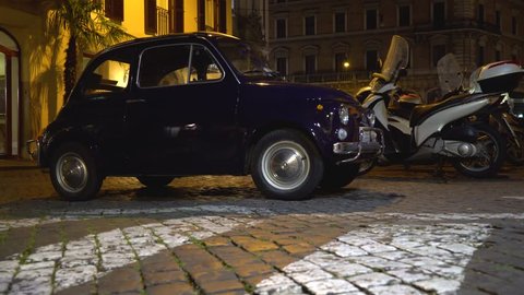Rome, Italy - 15 June 2018. Night view of old fashioned small car