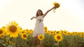 Happy little girl on the field of sunflowers in summer. beautiful little girl in sunflowers. slow motion video. girl teenager and sunflowers lifestyle field concept agriculture