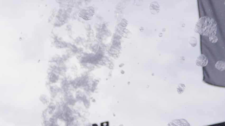 People at a fun summer foam party with bubbles and soap and wet wild excitement