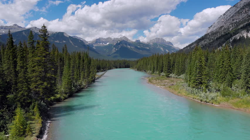 Banff National Park aerial view, flying over the Bow River in the Canadian Rockies during summer, Alberta, Canada. Royalty-Free Stock Footage #1014774977