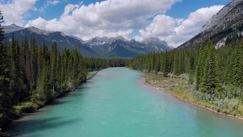 Banff National Park aerial view, flying over the Bow River in the Canadian Rockies during summer, Alberta, Canada. Royalty-Free Stock Footage #1014774977