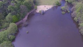 Aerial/Drone footage of the lake at Golden Acre Park in Leeds, England.