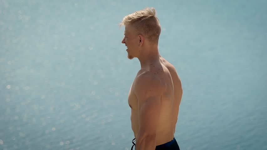 Sportsman doing squats with dumbbells and pushing them up.