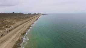 Flying over sea Fujairah coast beach aerial 4k video. View from above ocean water surface.