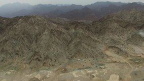 Flying over Fujairah mountains rocks desert landscape Aerial view background 4k video