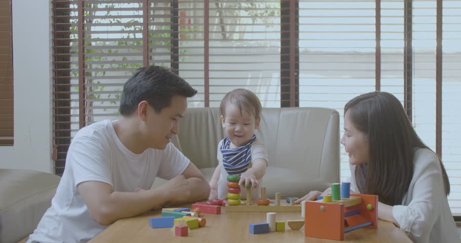 Happy mother, father and little asian boy playing with wooden toy blocks at home. Educational Toys for preschool and kindergarten child. | Shutterstock HD Video #1014791876