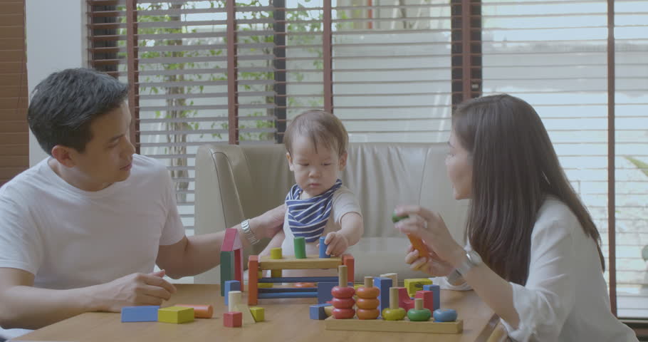 Happy mother, father and little asian boy playing with wooden toy blocks at home. Educational Toys for preschool and kindergarten child. | Shutterstock HD Video #1014791879