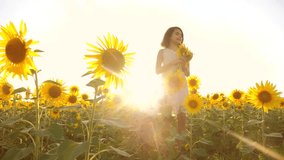 Cute child girl in yellow garden of lifestyle sunflowers sunlight in summer. beautiful sunset little girl in sunflowers. slow motion video. girl teenager and sunflowers field concept agriculture