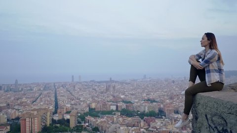Beautiful woman enjoying Barcelona city view from Bunkers del Carmel, Spain