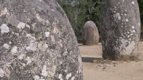 Monoliths Panning Shot Megalithic complex Standing Stones. The Cromlech of the Almendres is a megalithic complex located in the city of Evora, Portugal. - Powered by Shutterstock - Get 15% off with code: PIKWIZARD15