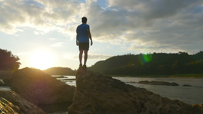 Man Resting On The Top Of Rock
