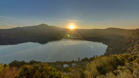Panoramic view of Albano Lake coast at sunrise timelapse, Rome Province, Latium, central Italy. Green trees at morning light