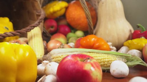 Autumnal Harvest or Thanksgiving, Cornucopia filled with vegetables, vegetables spilled out of the basket on the table. 4k, dolly shot