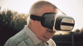 Elderly Man Using Virtual Reality Headset Outdoor. - Powered by Shutterstock - Get 15% off with code: PIKWIZARD15