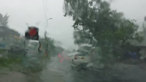 Heavy rain dangerous driving condition on road, taken from a car window Kerala India. Flooded city due to hurricane or cyclone. Accident prone condition due to blurred vision.