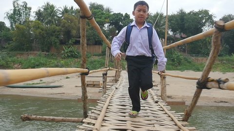 Asian Boy Student Running On Bamboo Bridge
