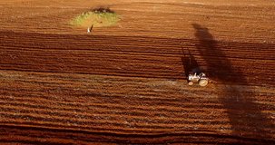 Aerial clip of a tractor moving on a red field in the Karatu area, Tanzania.