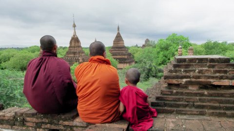Authentic real monks, over looking view of  Bagan Mayanmar / Burma looking back and smiling. 