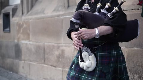 street artist - Scottish piper in Highland national dress