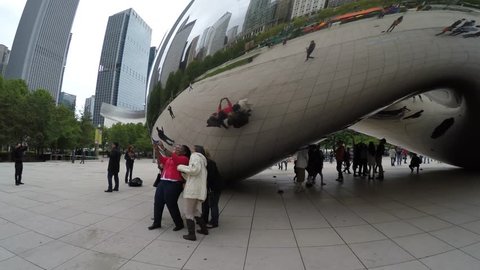 CHICAGO, UNITED STATES OF AMERICA - CIRCA MAY, 2015: Walking on the famous Chicago Cloud Gate, The Bean Sculpture in Millennium Park, Chicago, Illinois